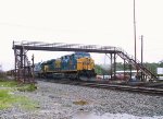 CSX 598 leads a southbound train parked under the pedestrian overpass (in a light rain)